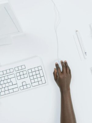 Top view of a minimalist workspace with a computer, keyboard, and tablet.